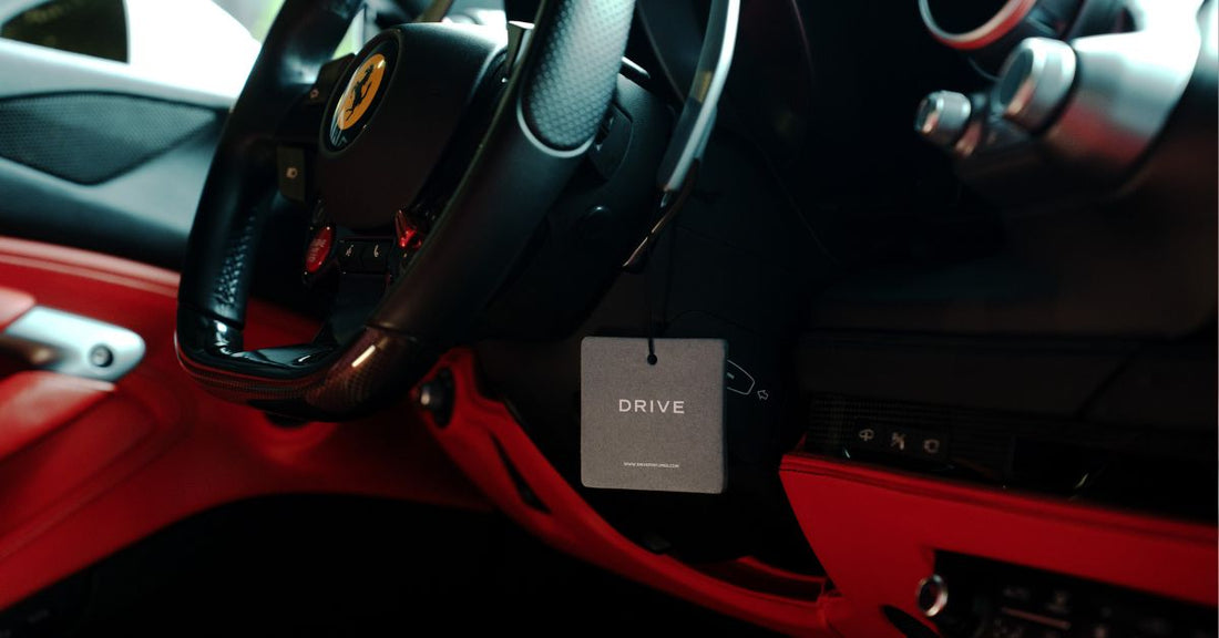 Drive hanging car perfume card in a Ferrari interior with red accents