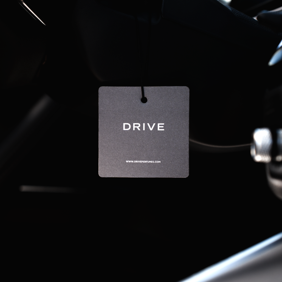 Drive hanging car perfume card in a dark car interior